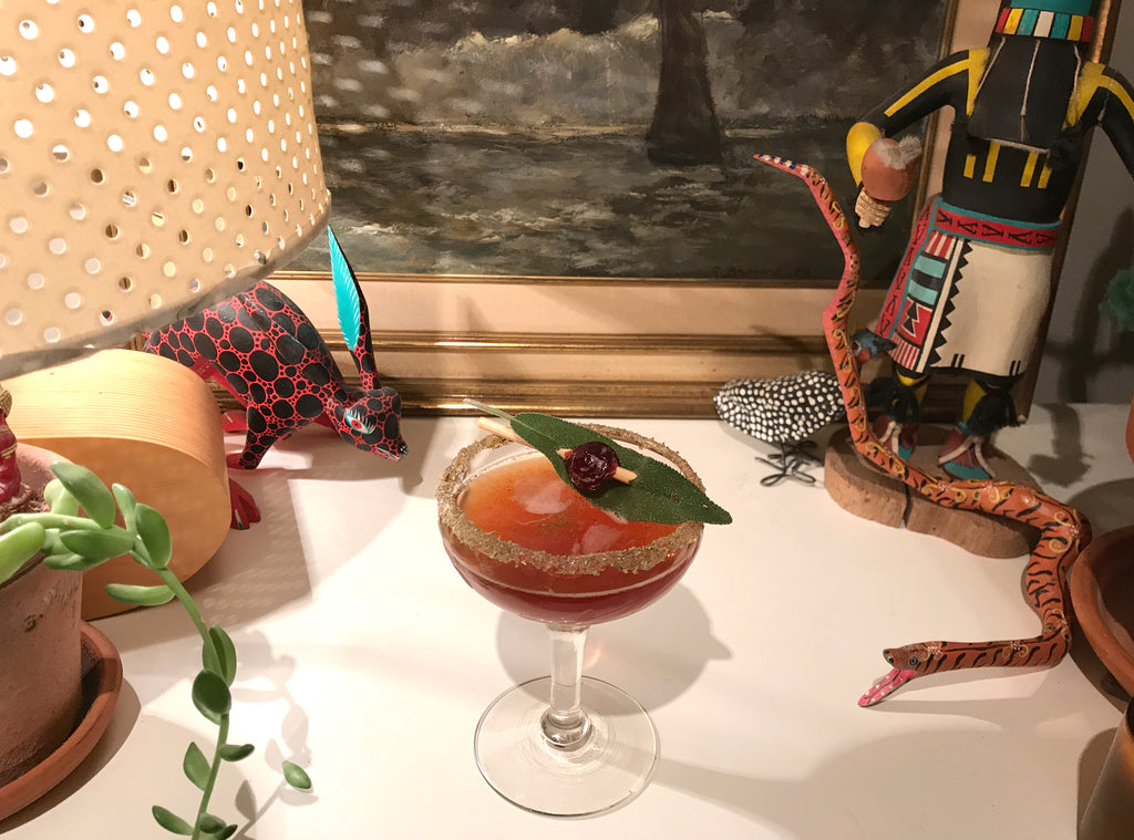 Our WINTER SUEÑO COCKTAIL served in a coupe glass,  garnished with a RedCamper Bourbon Cocktail Cherry 