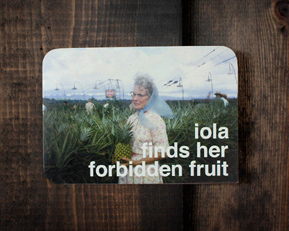 Retro Greeting Card 1960’s Image-woman in blue scarf with pineapple in pineapple field. Text- Iola Finds Her Forbidden Fruit 