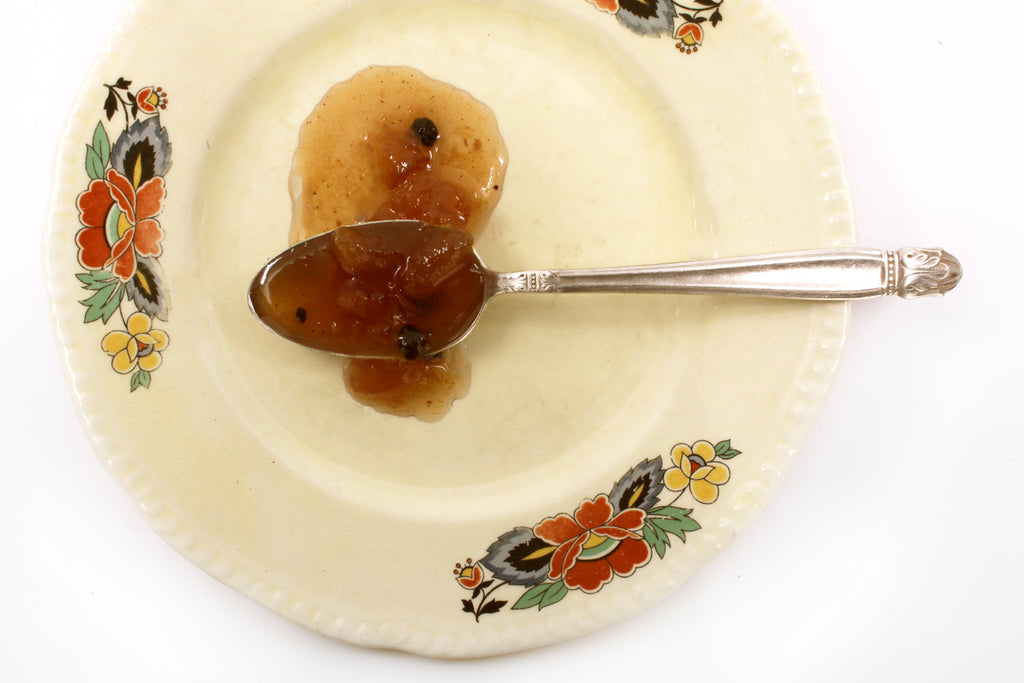 RedCamper Harvest Pear Preserves displayed on spoon- saucy texture with chunks of pear and currents flecked with cardamom  
